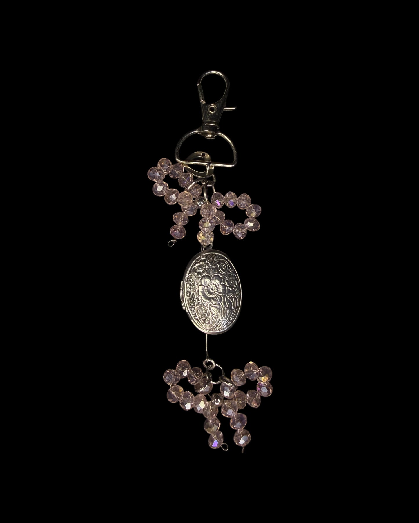 Coral bow captured the locket bag charm